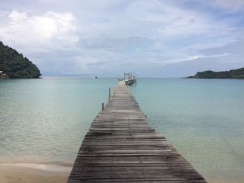 Pier over sea against sky