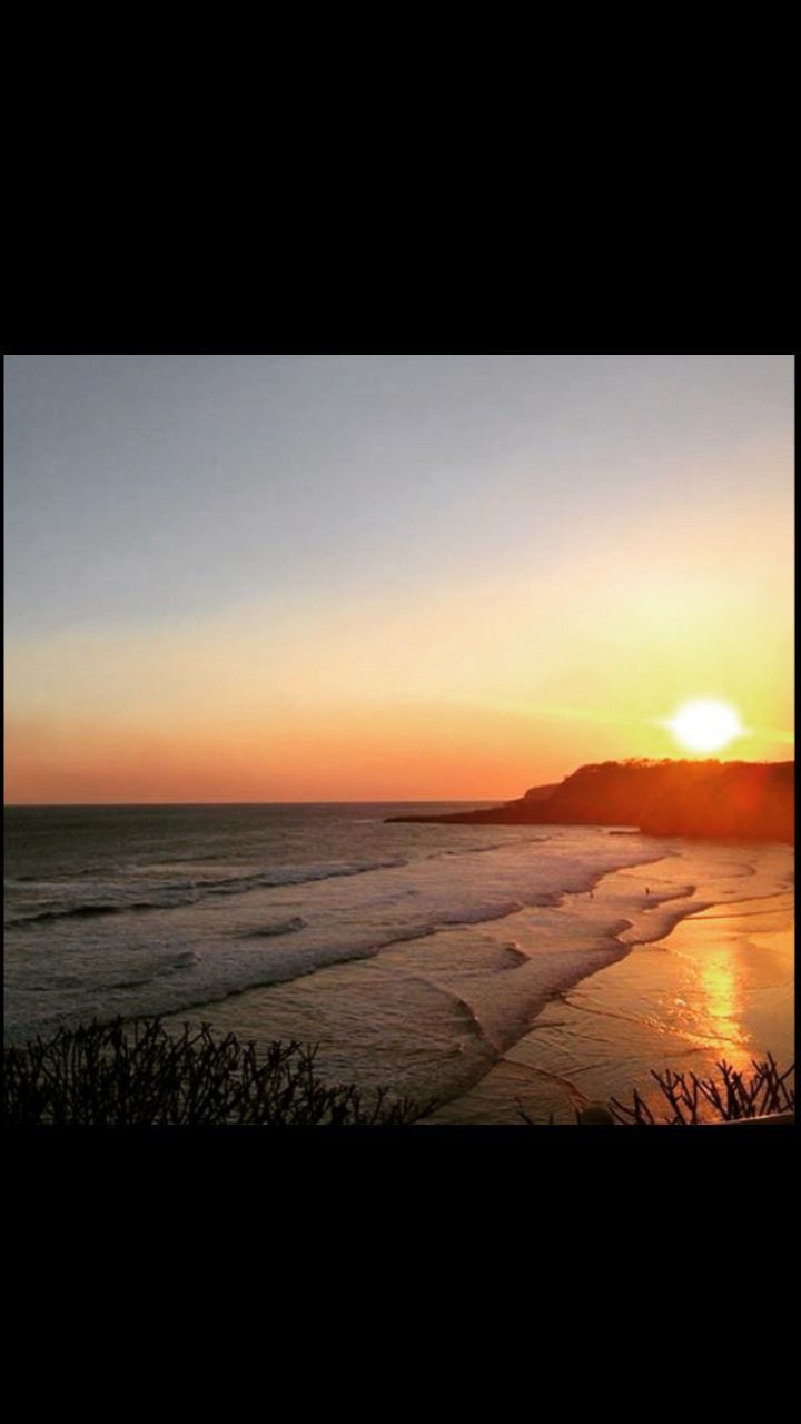 SCENIC VIEW OF BEACH AGAINST SKY DURING SUNSET