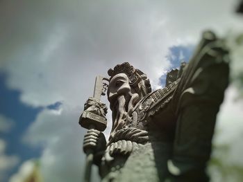 Silhouette of woman standing against cloudy sky