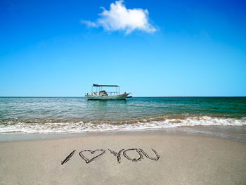 The boat is anchoring at the beautiful beach on a sunny day.