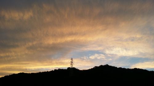 Silhouette of mountain against sky at sunset