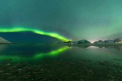 Scenic view of lake against sky at night