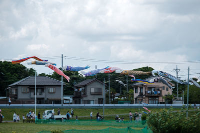 Group of people in front of built structure against sky