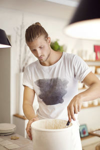 Mid adult man preparing food in kitchen