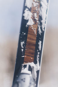 Close-up of cigarette against sky in winter