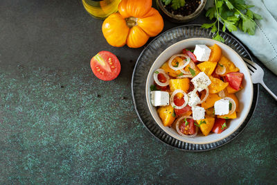 The concept of vegan or diet food. tomato salad made from a  tomatoes and feta cheese. 