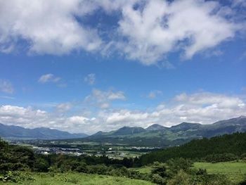 Scenic view of mountains against cloudy sky