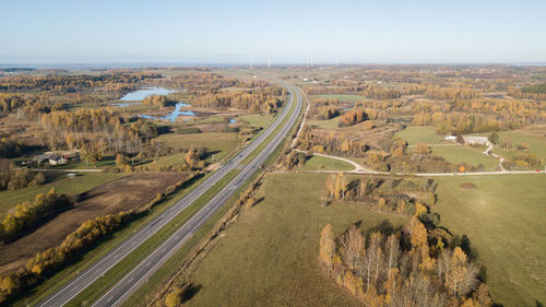 High angle view of road amidst field against sky