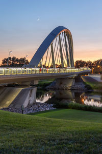 Bridge over river at sunset