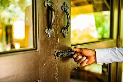 Cropped hand of man holding metal