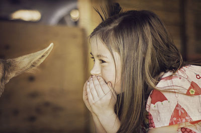 Close-up of cute girl whispering in ear