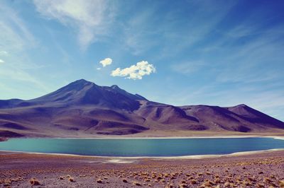 Scenic view of sea and mountains against sky