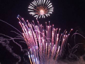 Low angle view of firework display at night