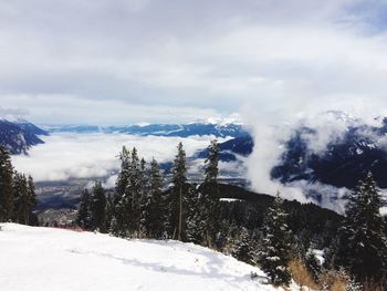 Scenic view of snow covered landscape against cloudy sky