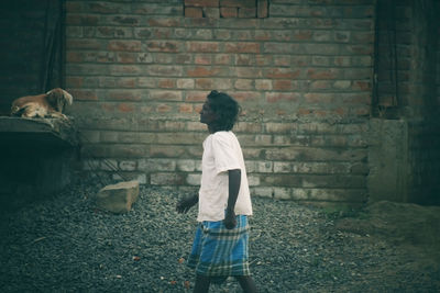 Rear view of man standing against wall