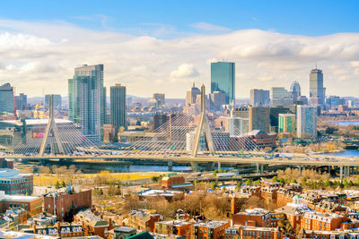 Aerial view of buildings in city against sky