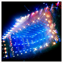 Low angle view of firework display at night