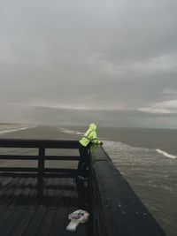 Man at pier during bad weather