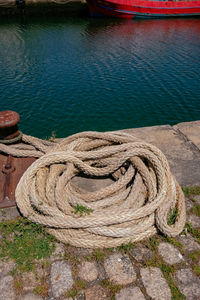 High angle view of rope tied to fishing at harbor