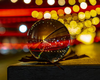 Close-up of illuminated christmas lights on glass table