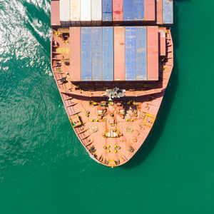 High angle view of boat moored in sea against building