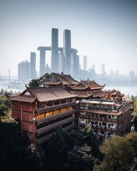 Buildings in city against clear sky