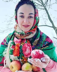 Portrait of happy woman with red flower