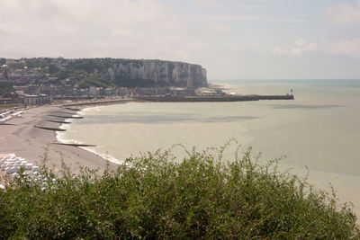 Scenic view of sea by city against sky