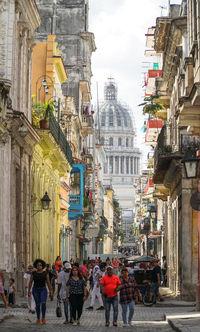 People on street amidst buildings in city