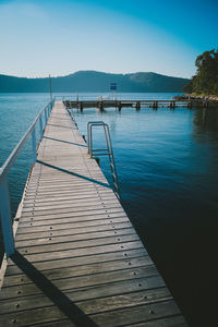 Pier over sea against clear sky