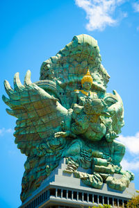 Low angle view of statue against blue sky