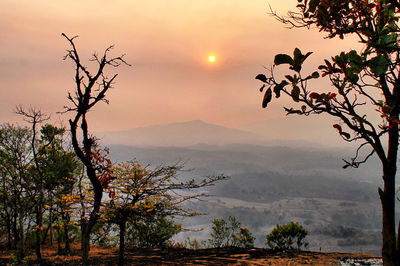 Scenic view of silhouette mountains against sky at sunset