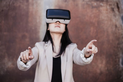 Chinese businesswoman using virtual reality headset. selective focus on hands. technology