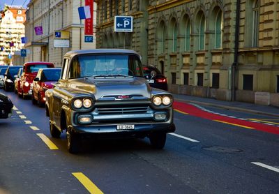 Cars on street by buildings in city