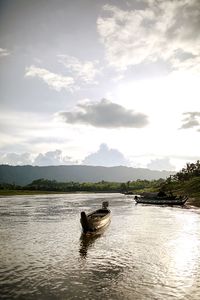 Boat in lake against sky