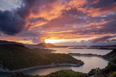 Scenic view of lake against sky during sunset