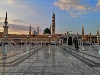 View of mosque in city against sky
