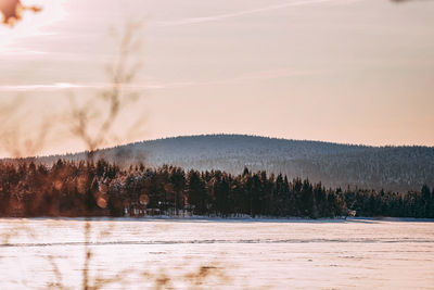 Scenic view of lake against sky at sunset