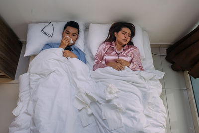 Full length of a young woman lying on bed