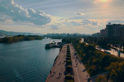 High angle view of river amidst city against sky