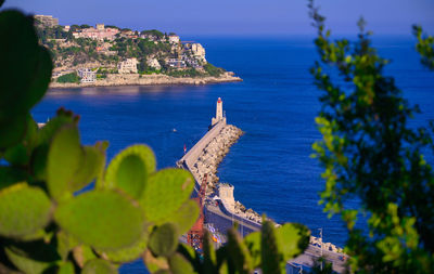 Scenic view of sea and buildings against sky