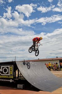 Man riding bicycle against sky