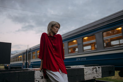 Woman looking at camera against sky