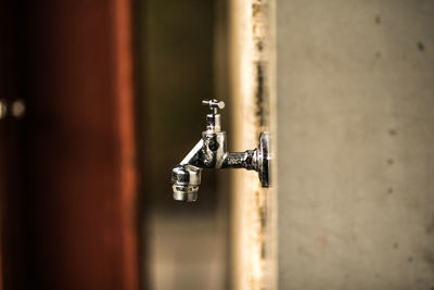 Close-up of faucet against white wall