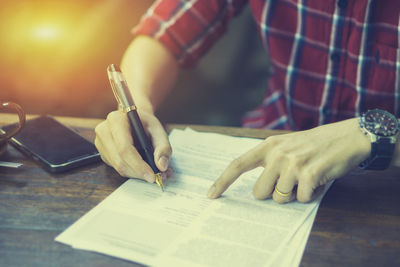 Close-up of man working on paper