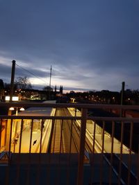 Illuminated bridge against sky at dusk