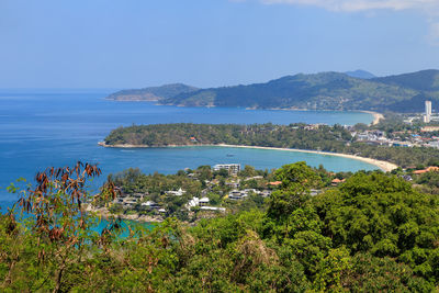 Scenic view of sea and mountains against sky