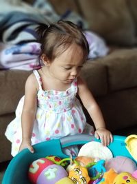 Cute baby girl sitting at toy