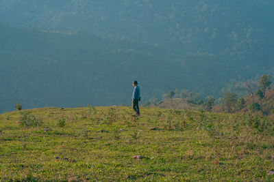 Rear view of man walking on mountain