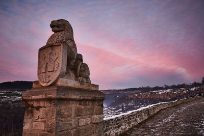 Low angle view of statue against sky during sunset